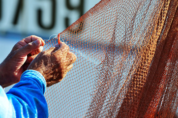 fisher clinches the fishing net