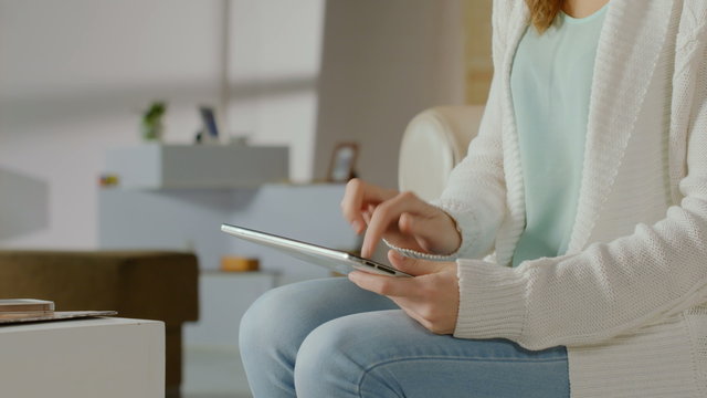 Girl communicating, chatting online in social networks on tablet