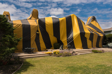 House is covered by tent for fumigation