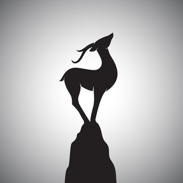 Vector image of a deer standing on the rocks.