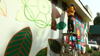 Modern urban art - Young man writing graffiti