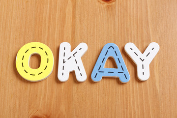 OKAY, spell by woody puzzle letters with woody background