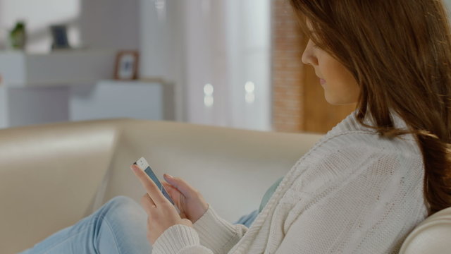 Beautiful lady typing, sending message, texting from smartphone 