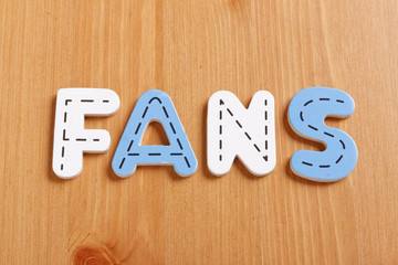FANS, spell by woody puzzle letters with woody background