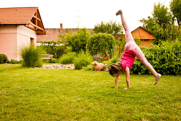 Child doing cartwheel in backyard