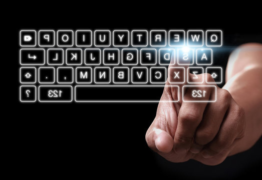Hand pressing on button of digital virtual keyboard