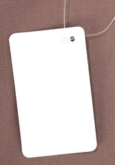 White blank paper tag price on brown background