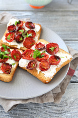 Bruschetta with sun-dried tomatoes and cheese on a plate