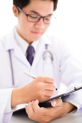 Close-up Of Male Doctor Filling The Medical Form