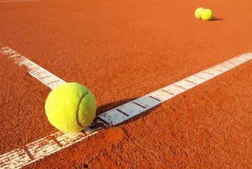 Fotobehang Tennis balls on a tennis clay court © Željko Radojko