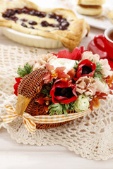 Bouquet of flowers in wicker goose. Table centerpiece idea