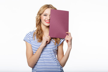 Happy young female holding a blank billboard on white background