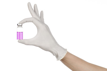 doctor's hand in a white glove holding a purple vial of liquid