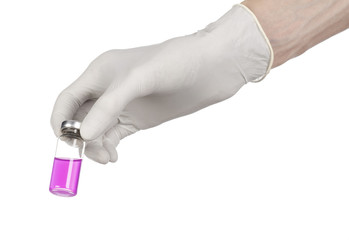doctor's hand in a white glove holding a purple vial of liquid