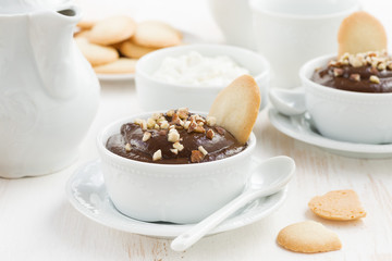 chocolate mousse with biscuits and nuts in cups