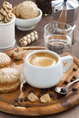 fresh espresso, cookies and a glass of water on wooden tray