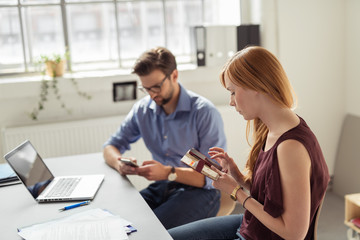 zwei junge geschäftsleute tippen auf ihre handy