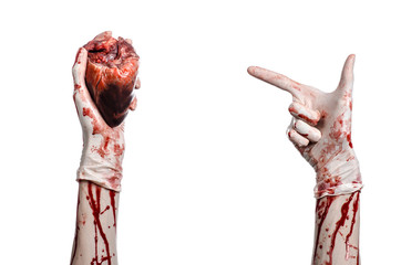 Bloody hand surgeon holding a human heart in a white gloves