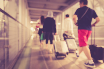 Fototapeta na wymiar Blurred background : People walking in the airport