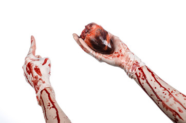 Bloody hand surgeon holding a human heart in a white gloves