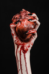 bloody hands with black nails holding bloody human heart - 83754071