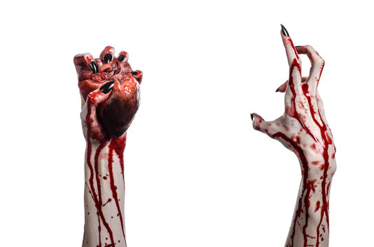 bloody hands with black nails holding bloody human heart