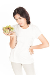 Pretty girl eating fresh vegetable salad