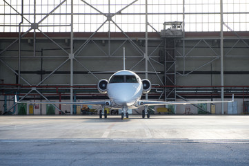 Business jet airplane is in hangar.