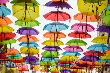Fototapeta na wymiar Colorful umbrellas up in the sky