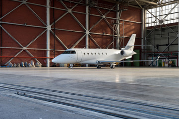 Business jet airplane is in hangar.