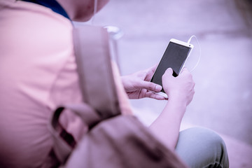 students sitting on stairs with their smartphones