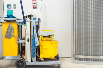 Yellow mop bucket and set of cleaning equipment