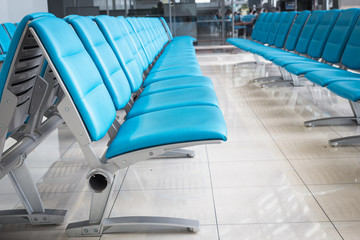 row of blue chair in the airport