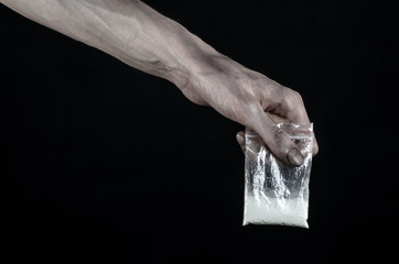 dirty hand holding a bag addict cocaine in the studio