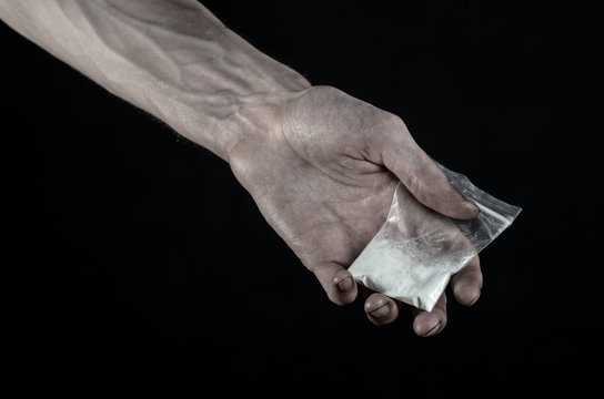 dirty hand holding a bag addict cocaine in the studio