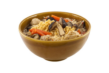 Noodles in bowl with vegatables and meatballs isolated on white