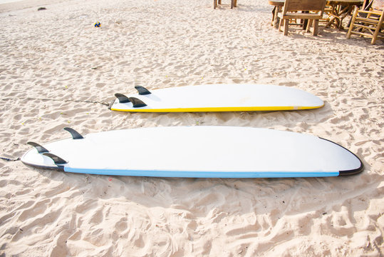 surfboards on sand at the beach