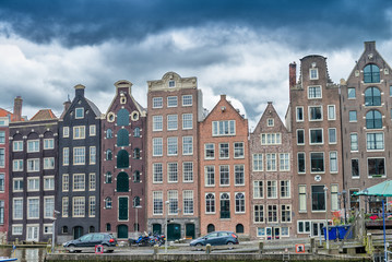 Fototapeta na wymiar Beautiful houses of Amsterdam along city canal