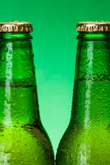 Macro of wet green beer bottles