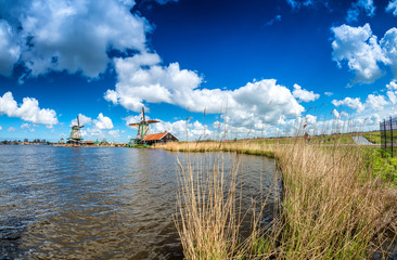Fototapeta premium Zaanse Schans windmills along city canal, Netherlands