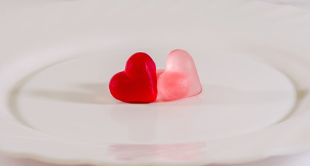 Colored heart shape jellies on a white plate