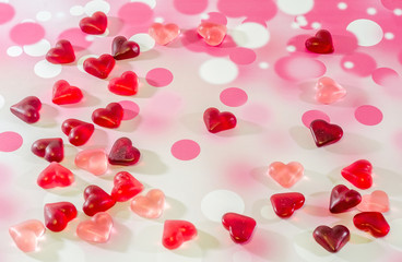 Colored heart shape jellies on a colored background