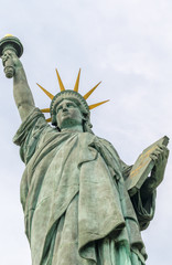 Fototapeta na wymiar Statue of Liberty in Paris. Bottom-Up view from street