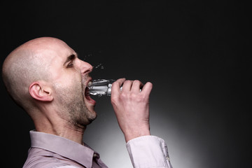 man drink water ore vodka with drops