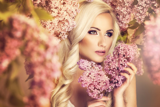 Beauty fashion model girl with lilac flowers