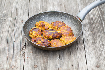 vegetable cutlets in a frying pan on the table