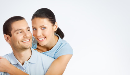 Naklejka premium Portrait of cheerful smiling young couple, with copyspace
