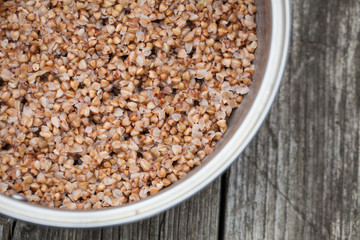 buckwheat cereal in a pot on a wooden table