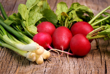 fresh radish with leek on nwooden board