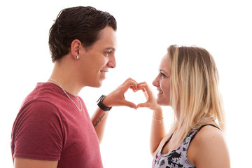 Young couple making heart with hands